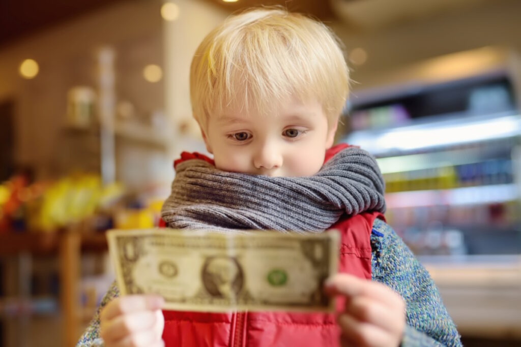 recycling metal boy holds one dollar